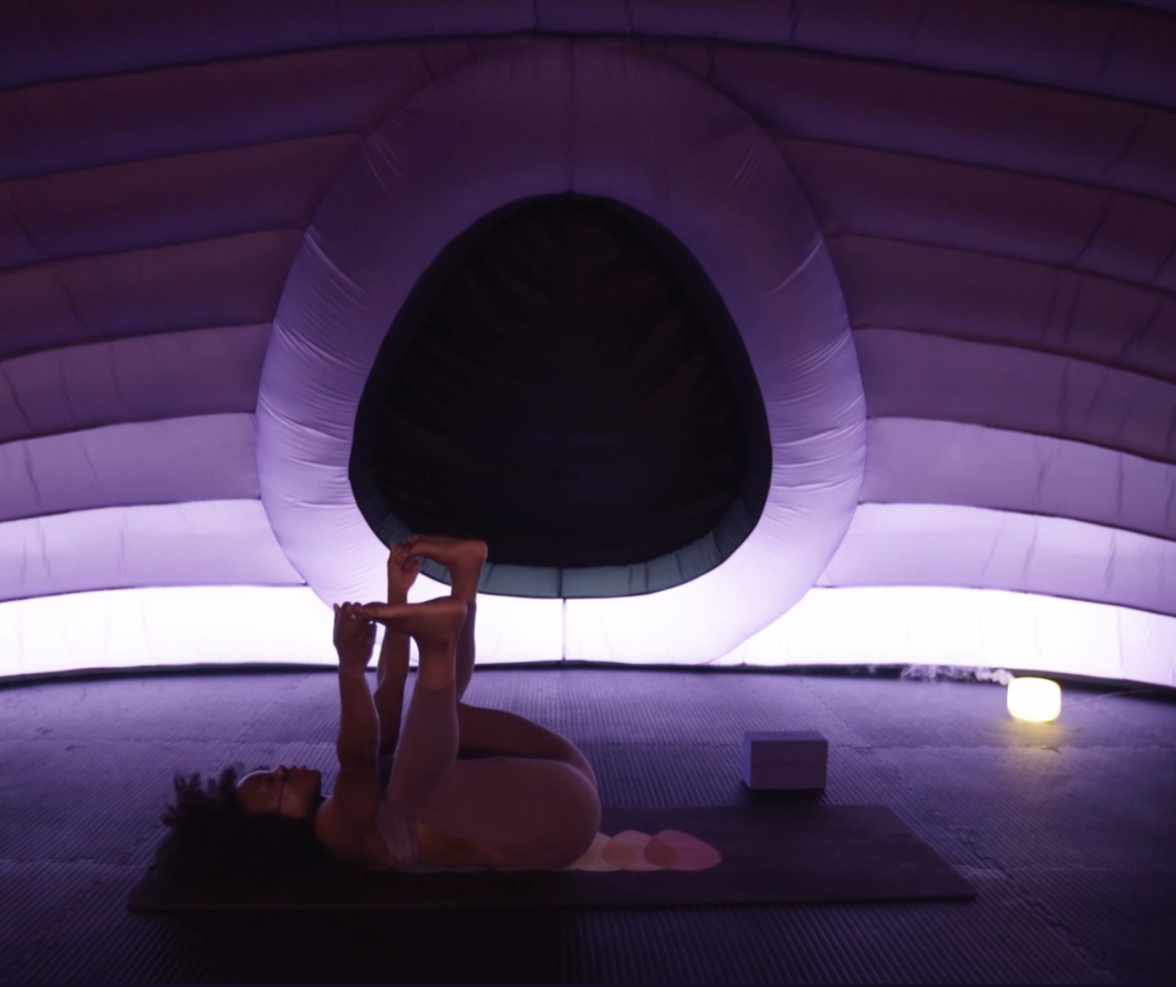 Demonstration of a Happy Baby yoga pose